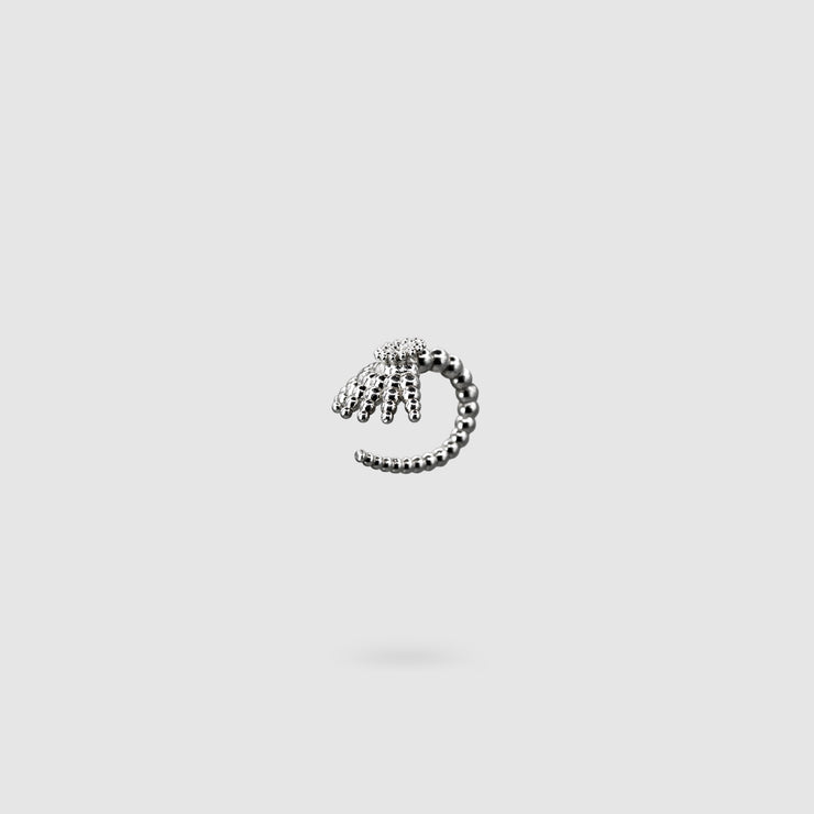This finely detailed ear cuff from the PHAOS collection offers an innovative reinterpretation of the ancient granulation technique, brought to life through digital design and modern craftsmanship. Its sculptural form wraps elegantly around the ear without the need for a piercing, creating a bold yet refined statement. Available in your choice of gold-plated brass or .925 silver, it’s a contemporary piece that merges heritage with high-tech precision.