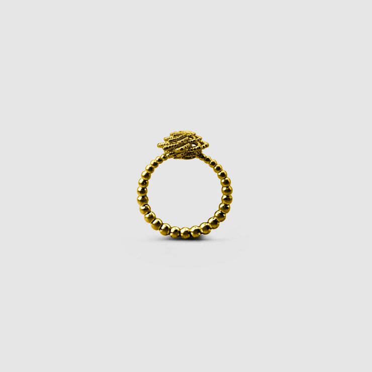A bold reinterpretation of a timeless halo design, this ring fuses the ancient granulation technique with contemporary digital craftsmanship. Its sculptural silhouette and delicate design details make it a standout piece, expertly crafted in gold-plated brass or .925 silver as part of the PHAOS collection.