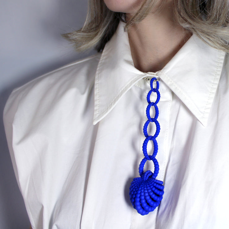 With its fluid Y silhouette and finely interlocking details, this pendant is crafted from bioplastic and suspended from a .925 silver chain. Hand-dyed in your choice of colour, it’s a subtly seductive piece that reinterprets the ancient art of granulation through a modern lens.