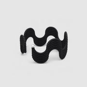 This lightweight cuff bracelet from the PHAOS collection is crafted from hand-dyed, 3D printed bioplastic and accented with glass pearls. Made from a renewable, plant-based polyamide derived from vegetable oil, each piece is hand-finished in your choice of colour; blending sustainable innovation with bold, contemporary design.