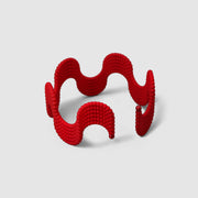 This lightweight cuff bracelet from the PHAOS collection is crafted from hand-dyed, 3D printed bioplastic and accented with glass pearls. Made from a renewable, plant-based polyamide derived from vegetable oil, each piece is hand-finished in your choice of colour; blending sustainable innovation with bold, contemporary design.