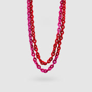 Playful chain necklace from 3D printed bioplastic of the PHAOS collection, hand-dyed in royal blue or a pink and red hue. Wrap it once, twice, or three times around the neck to complement your outfit with a pop of colour. Features a secure clasp fastening made from silver .925