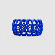 Playful bangle bracelet from 3D printed bioplastic of the PHAOS collection, hand-dyed in royal blue or a pink and red hue. This material is a polyamide powder made out of renewable resources that come from vegetable oil.