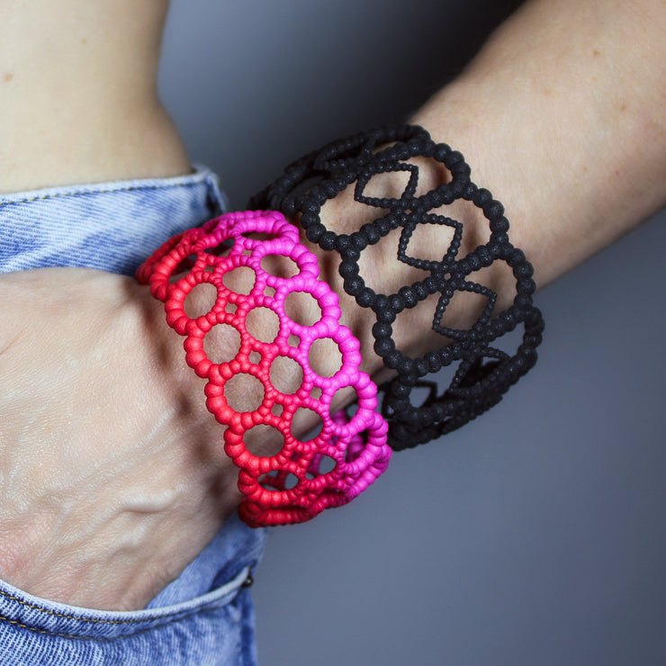 Playful bangle bracelet from 3D printed bioplastic of the PHAOS collection, hand-dyed in royal blue or a pink and red hue. This material is a polyamide powder made out of renewable resources that come from vegetable oil.