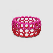 Playful bangle bracelet from 3D printed bioplastic of the PHAOS collection, hand-dyed in royal blue or a pink and red hue. This material is a polyamide powder made out of renewable resources that come from vegetable oil.