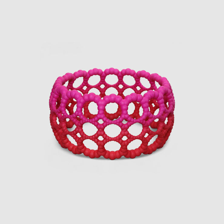Playful bangle bracelet from 3D printed bioplastic of the PHAOS collection, hand-dyed in royal blue or a pink and red hue. This material is a polyamide powder made out of renewable resources that come from vegetable oil.