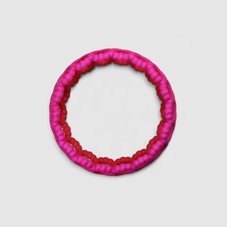 Playful bangle bracelet from 3D printed bioplastic of the PHAOS collection, hand-dyed in royal blue or a pink and red hue. This material is a polyamide powder made out of renewable resources that come from vegetable oil.