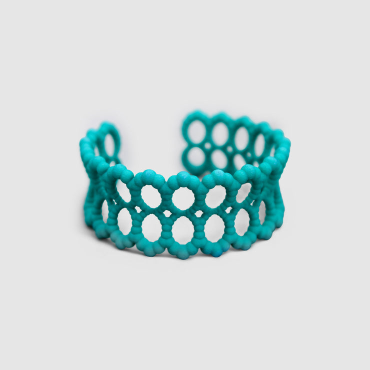 Turquoise cuff bracelet from the PHAOS collection, 3D printed in bioplastic, a polyamide powder made out of renewable resources that come from vegetable oil.