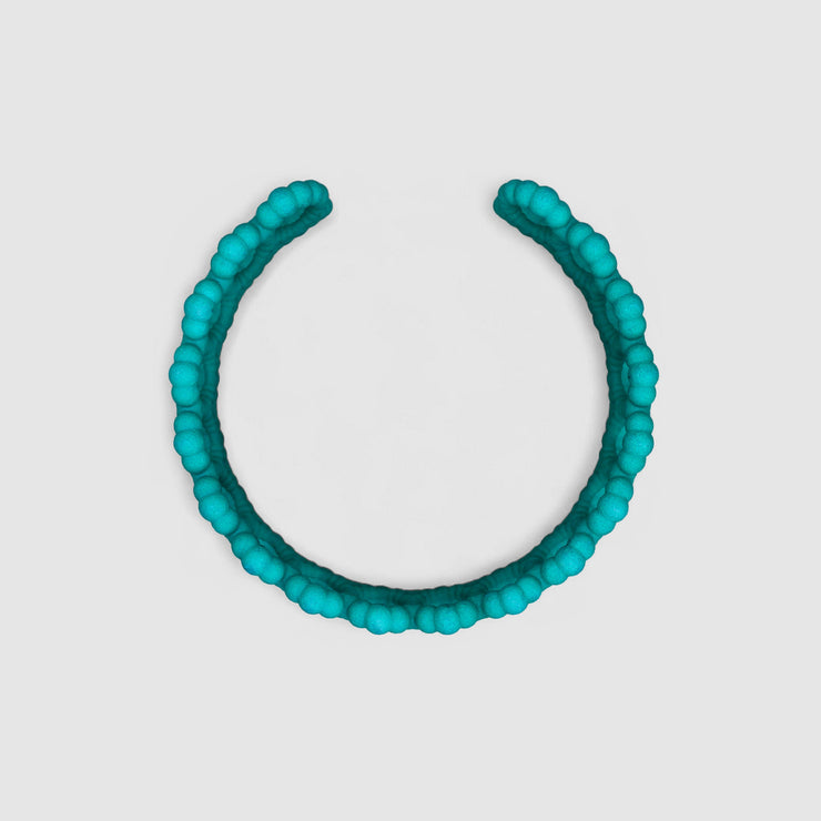 Turquoise cuff bracelet from the PHAOS collection, 3D printed in bioplastic, a polyamide powder made out of renewable resources that come from vegetable oil.