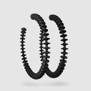 These bold, modern hoop earrings pay homage to the ancient technique of granulation - reimagined through a futuristic lens. Crafted from 3D-printed bioplastic, they’re finished with our signature .925 silver post fastening for all-day comfort on pierced ears.