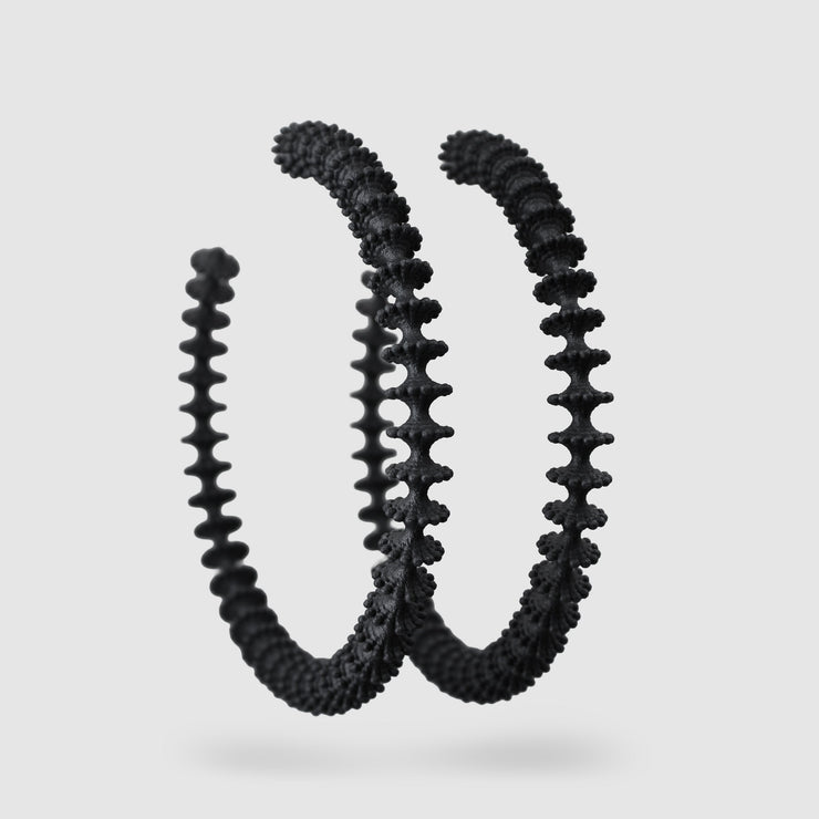 These bold, modern hoop earrings pay homage to the ancient technique of granulation - reimagined through a futuristic lens. Crafted from 3D-printed bioplastic, they’re finished with our signature .925 silver post fastening for all-day comfort on pierced ears.