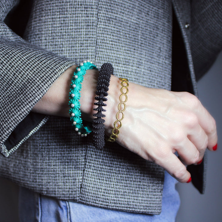 Delicate but daring bangle crafted in gold plated brass or silver .925 and powered by scientific inspiration. Stack this best-selling bracelet with others on a bare wrist, or wear it alone over a shirt sleeve for an elegant twist.