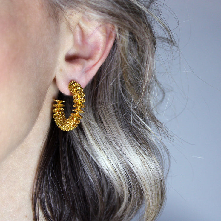 Our best selling hoop earrings from the PHAOS collection are crafted in gold plated brass, silver .925 or gold plated silver .925 and feature a playful yet delicate pattern. Decisively designed to enhance your everyday signature style. Finished with our signature post fastening for all-day comfort on pierced ears.