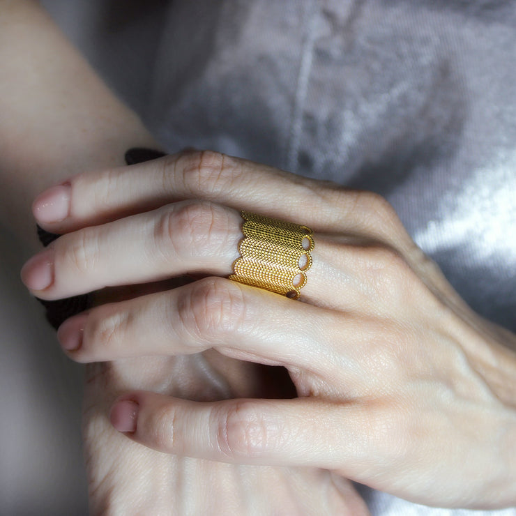 A seriously chunky ring from the PHAOS collection crafted in gold plated brass, silver .925 or gold plated silver .925. As this is a wide fitting ring, it’s always best to size up on your usual ring size. Featuring a contemporary twist to the ancient technique of granulation, it has a lovely feel and looks stunning on any finger.