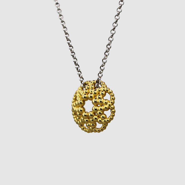 An artfully detailed pendant with a striking geometric form, crafted from gold-plated brass and paired with a .925 silver chain from the PHAOS collection. Make a subtle statement by layering it along with other pieces. Bold yet delicate, this pendant necklace makes the perfect gift.