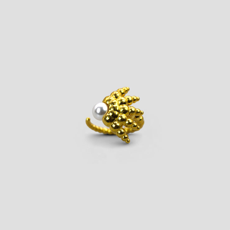 This open ring reimagines the ancient granulation technique with a fresh, contemporary edge, uniting heritage craftsmanship with modern design. Crafted in gold-plated brass or .925 silver as part of the PHAOS collection, it features an artful balance of form and texture, finished with a luminous glass bead for a distinctive statement.