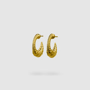 Expertly crafted from gold-plated brass or silver .925, these earrings strike the perfect balance between sophistication and sensuality with their sleek silhouette and minimalist design. If you gravitate toward earrings that are polished, daring, and effortlessly fashion-forward, then these are made for you.