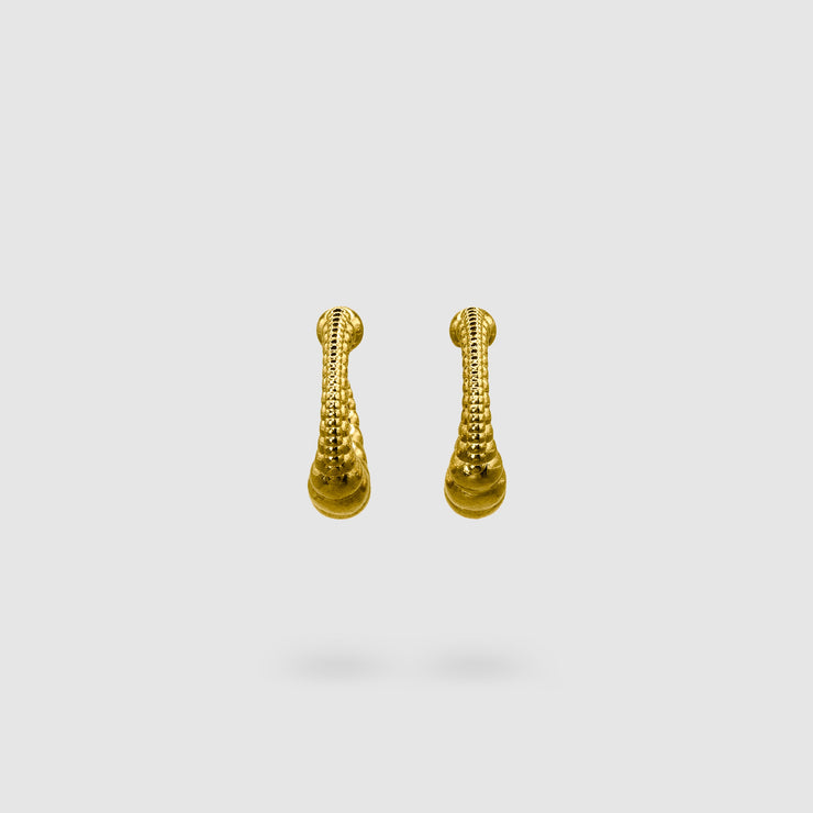Expertly crafted from gold-plated brass or silver .925, these earrings strike the perfect balance between sophistication and sensuality with their sleek silhouette and minimalist design. If you gravitate toward earrings that are polished, daring, and effortlessly fashion-forward, then these are made for you.