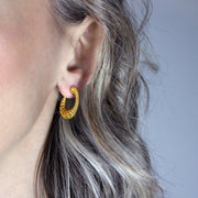 Expertly crafted from gold-plated brass or silver .925, these earrings strike the perfect balance between sophistication and sensuality with their sleek silhouette and minimalist design. If you gravitate toward earrings that are polished, daring, and effortlessly fashion-forward, then these are made for you.
