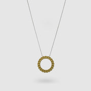 Striking yet refined, this pendant features an artfully detailed, geometric design crafted from gold-plated brass and suspended from a .925 silver chain - part of the PHAOS collection. Whether worn alone or layered with other pieces, it adds a subtle edge to any look. 
