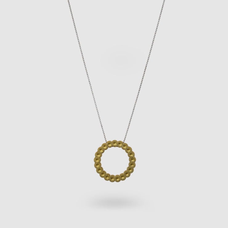 Striking yet refined, this pendant features an artfully detailed, geometric design crafted from gold-plated brass and suspended from a .925 silver chain - part of the PHAOS collection. Whether worn alone or layered with other pieces, it adds a subtle edge to any look. 