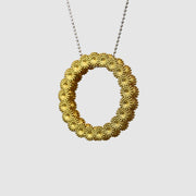 Striking yet refined, this pendant features an artfully detailed, geometric design crafted from gold-plated brass and suspended from a .925 silver chain - part of the PHAOS collection. Whether worn alone or layered with other pieces, it adds a subtle edge to any look. 