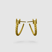 Sleek yet full of character, these wave hoop earrings from the PHAOS collection showcase a fluid, playful pattern with a refined touch. Available in gold-plated brass or .925 silver, they’re designed to add a hint of shine and movement to your everyday look. Finished with our signature post fastening for a secure, all-day comfortable fit on pierced ears.