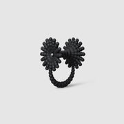 This eye-catching, geometric cocktail ring is 3D printed from a bioplastic made out of renewable resources that come from castor beans. Hand-dyed and finished with care, each piece features a subtle touch of .925 silver - a playful blend of tradition and forward-thinking design.