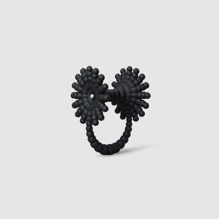 This eye-catching, geometric cocktail ring is 3D printed from a bioplastic made out of renewable resources that come from castor beans. Hand-dyed and finished with care, each piece features a subtle touch of .925 silver - a playful blend of tradition and forward-thinking design.