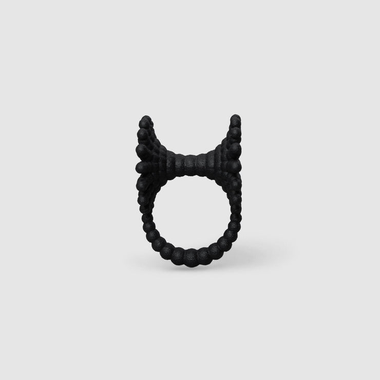 This eye-catching, geometric cocktail ring is 3D printed from a bioplastic made out of renewable resources that come from castor beans. Hand-dyed and finished with care, each piece features a subtle touch of .925 silver - a playful blend of tradition and forward-thinking design.