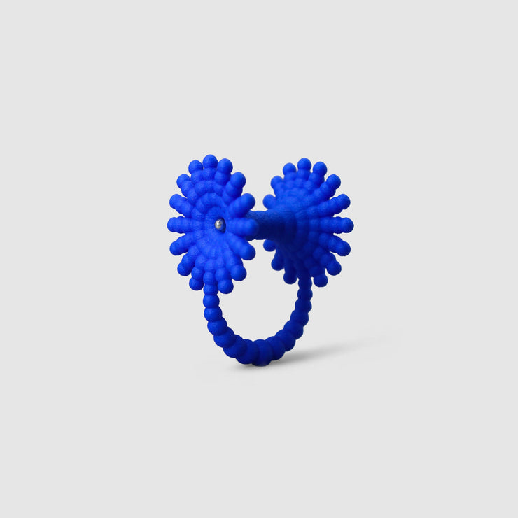 This eye-catching, geometric cocktail ring is 3D printed from a bioplastic made out of renewable resources that come from castor beans. Hand-dyed and finished with care, each piece features a subtle touch of .925 silver - a playful blend of tradition and forward-thinking design.