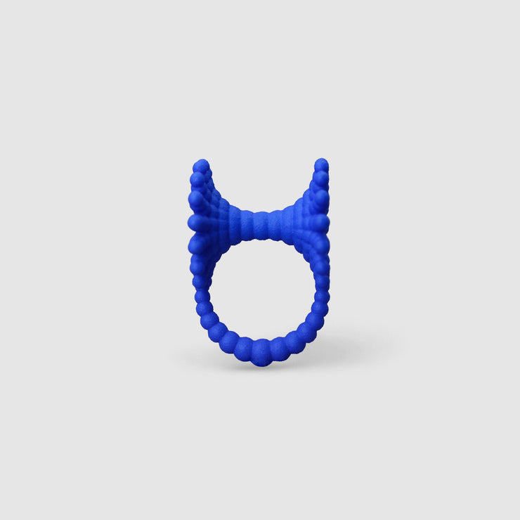 This eye-catching, geometric cocktail ring is 3D printed from a bioplastic made out of renewable resources that come from castor beans. Hand-dyed and finished with care, each piece features a subtle touch of .925 silver - a playful blend of tradition and forward-thinking design.