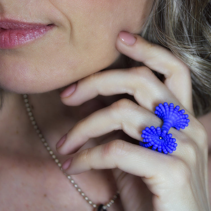 This eye-catching, geometric cocktail ring is 3D printed from a bioplastic made out of renewable resources that come from castor beans. Hand-dyed and finished with care, each piece features a subtle touch of .925 silver - a playful blend of tradition and forward-thinking design.