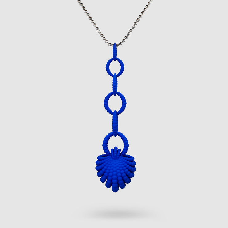 With its fluid Y silhouette and finely interlocking details, this pendant is crafted from bioplastic and suspended from a .925 silver chain. Hand-dyed in royal blue or peacock teal, it’s a subtly seductive piece that reinterprets the ancient art of granulation through a modern lens.
