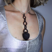 With its fluid Y silhouette and finely interlocking details, this pendant is crafted from bioplastic and suspended from a .925 silver chain. Hand-dyed in royal blue or peacock teal, it’s a subtly seductive piece that reinterprets the ancient art of granulation through a modern lens.