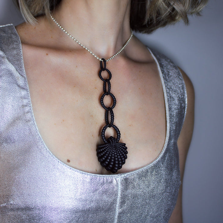 With its fluid Y silhouette and finely interlocking details, this pendant is crafted from bioplastic and suspended from a .925 silver chain. Hand-dyed in royal blue or peacock teal, it’s a subtly seductive piece that reinterprets the ancient art of granulation through a modern lens.