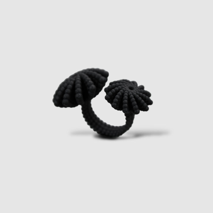 A bold statement piece with a sculptural edge, this open-band cocktail ring offers a contemporary take on the ancient art of granulation. 3D printed from a biosourced plastic known for its strength and distinctive sandy texture, each ring is hand-dyed and finished with care; a playful fusion of innovation and tradition.