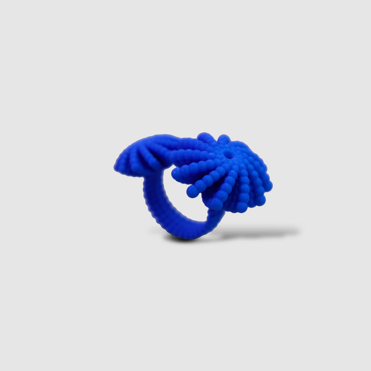 A bold statement piece with a sculptural edge, this open-band cocktail ring offers a contemporary take on the ancient art of granulation. 3D printed from a biosourced plastic known for its strength and distinctive sandy texture, each ring is hand-dyed and finished with care; a playful fusion of innovation and tradition.