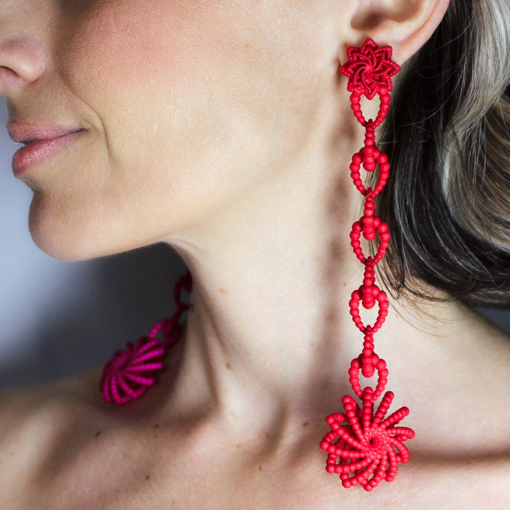Crafted from ultra-light, 3D-printed bioplastic, these head-turning earrings are a true statement piece. Part of the captivating PHAOS collection, they feature a hand-dyed finish - one in bold red, the other in vibrant pink - bringing a playful contrast to any look. Finished with our signature post fastening for all-day comfort on pierced ears.