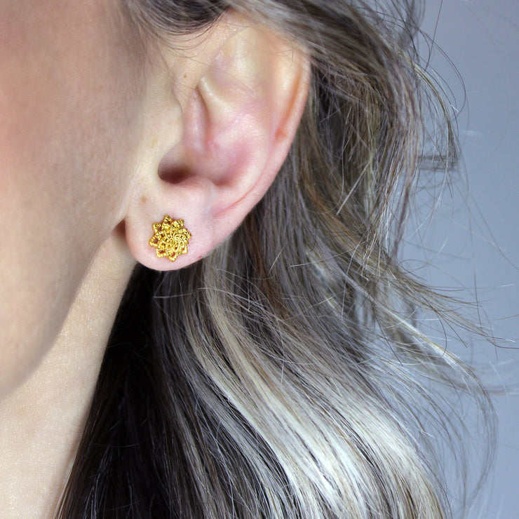 Delicate yet distinctive, these tiny stud earrings offer a modern take on a timeless form, inspired by the ancient art of granulation. Thoughtfully crafted in your choice of gold-plated brass or .925 silver, they’re versatile enough to elevate any look - whether worn alone or layered for added impact.