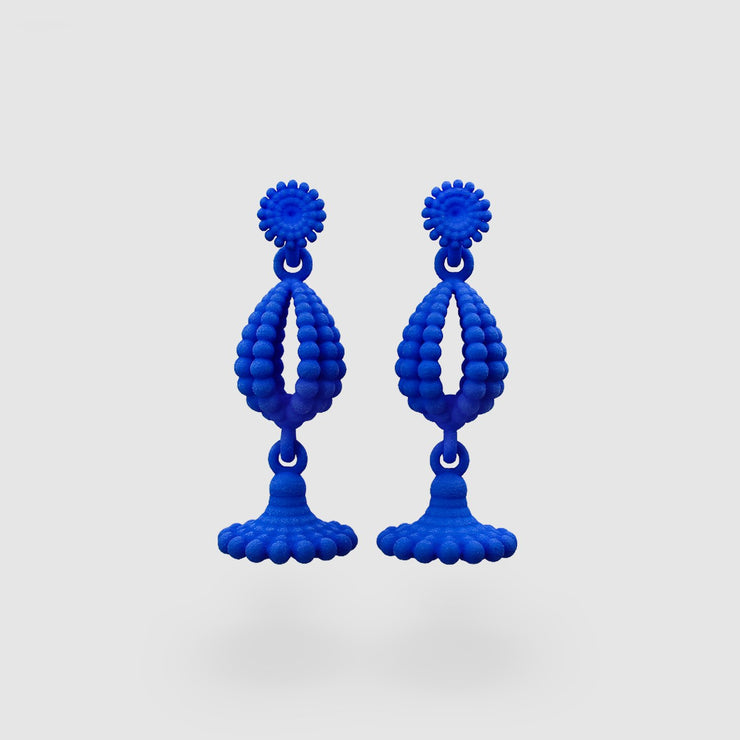 Vigorous drop earrings in fluid sculptural form. Created with selective laser sintering technology from polyamide which is a strong material that has a sandy look these earrings are hand finished with silver .925 elements and colour dye.