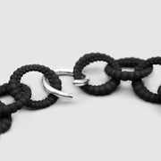 An interweaving standout this 2 in 1 necklace is crafted from durable nylon and hand dyed in black. It features a circular silver .925 closure which holds the pendant and can be deconstructed to a long minimalist chain necklace hence 2 in 1!